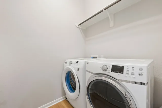 a view of washer and dryer with kitchen in the background
