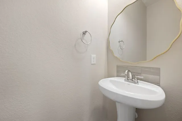 a bathroom with a sink a mirror and shower