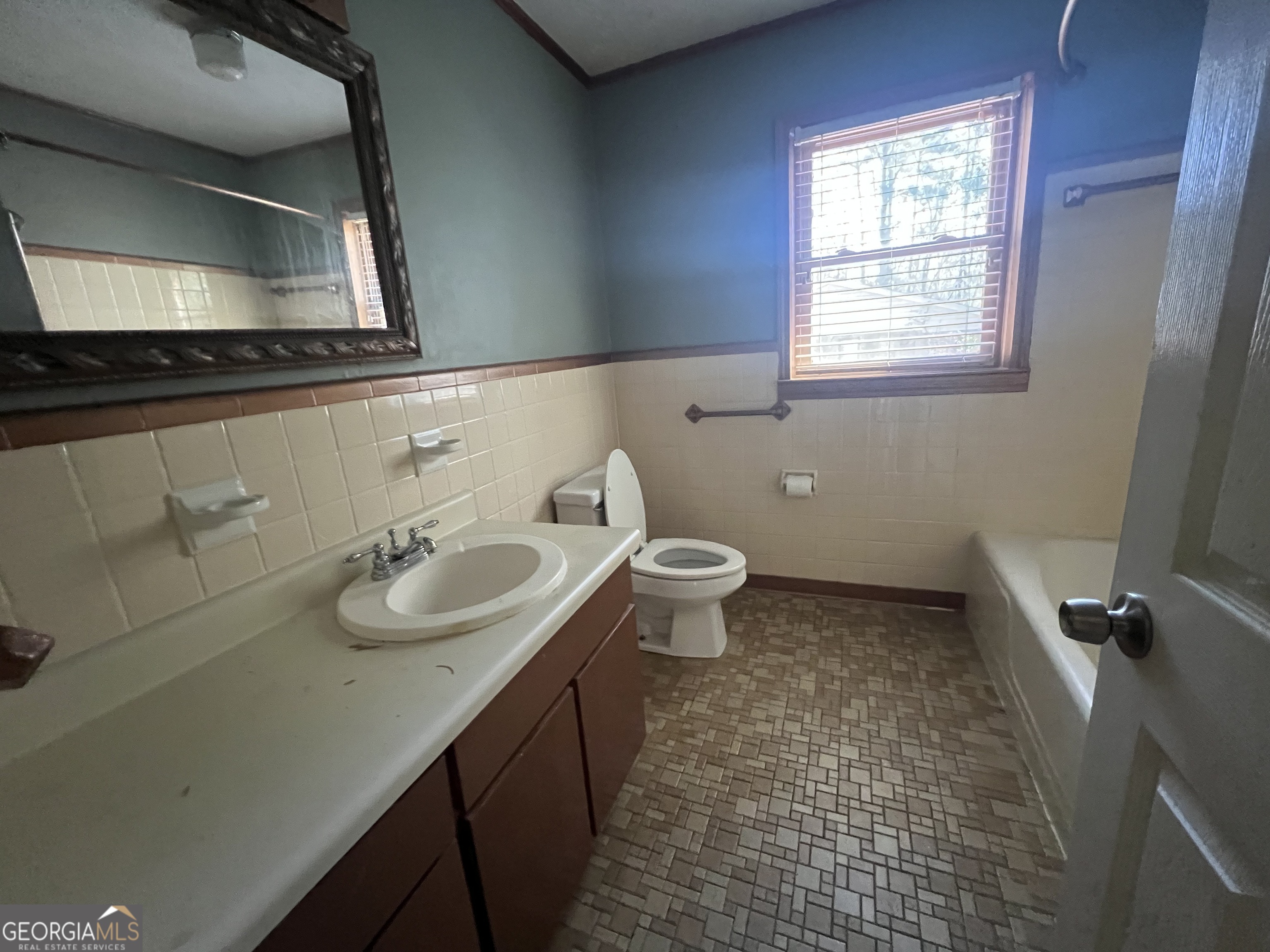 1342 North Jefferson Street Dublin, GA 31021 - Photo 14 of 15 a bathroom with a sink and a mirror