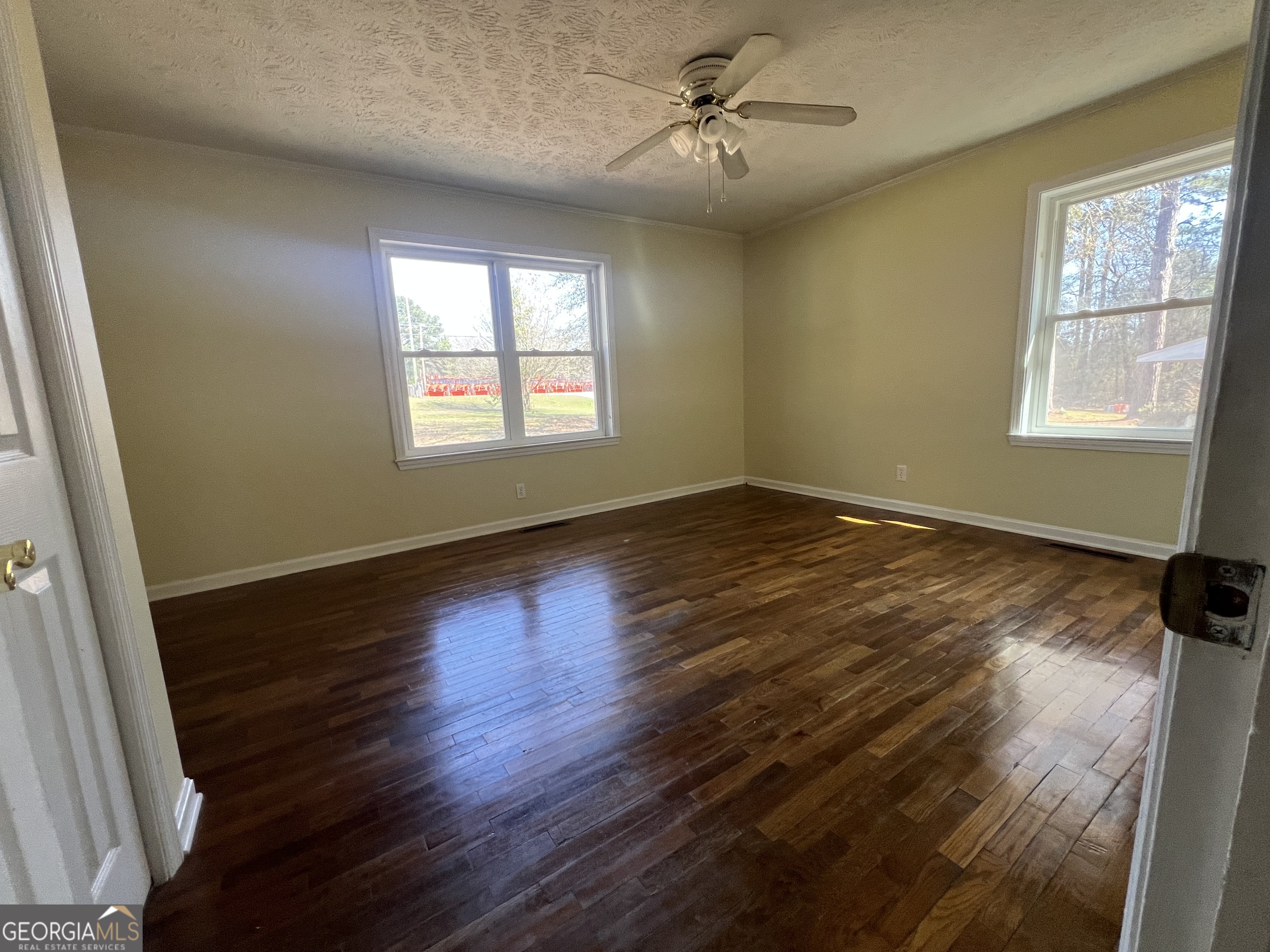 1342 North Jefferson Street Dublin, GA 31021 - Photo 15 of 15 a view of an empty room with wooden floor and a window