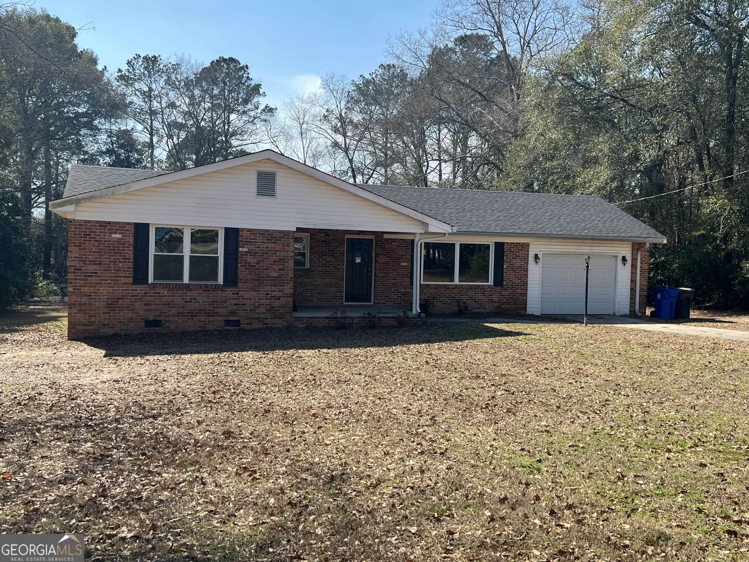 1342 North Jefferson Street Dublin, GA 31021 - Photo 2 of 15 a front view of a house with a garden