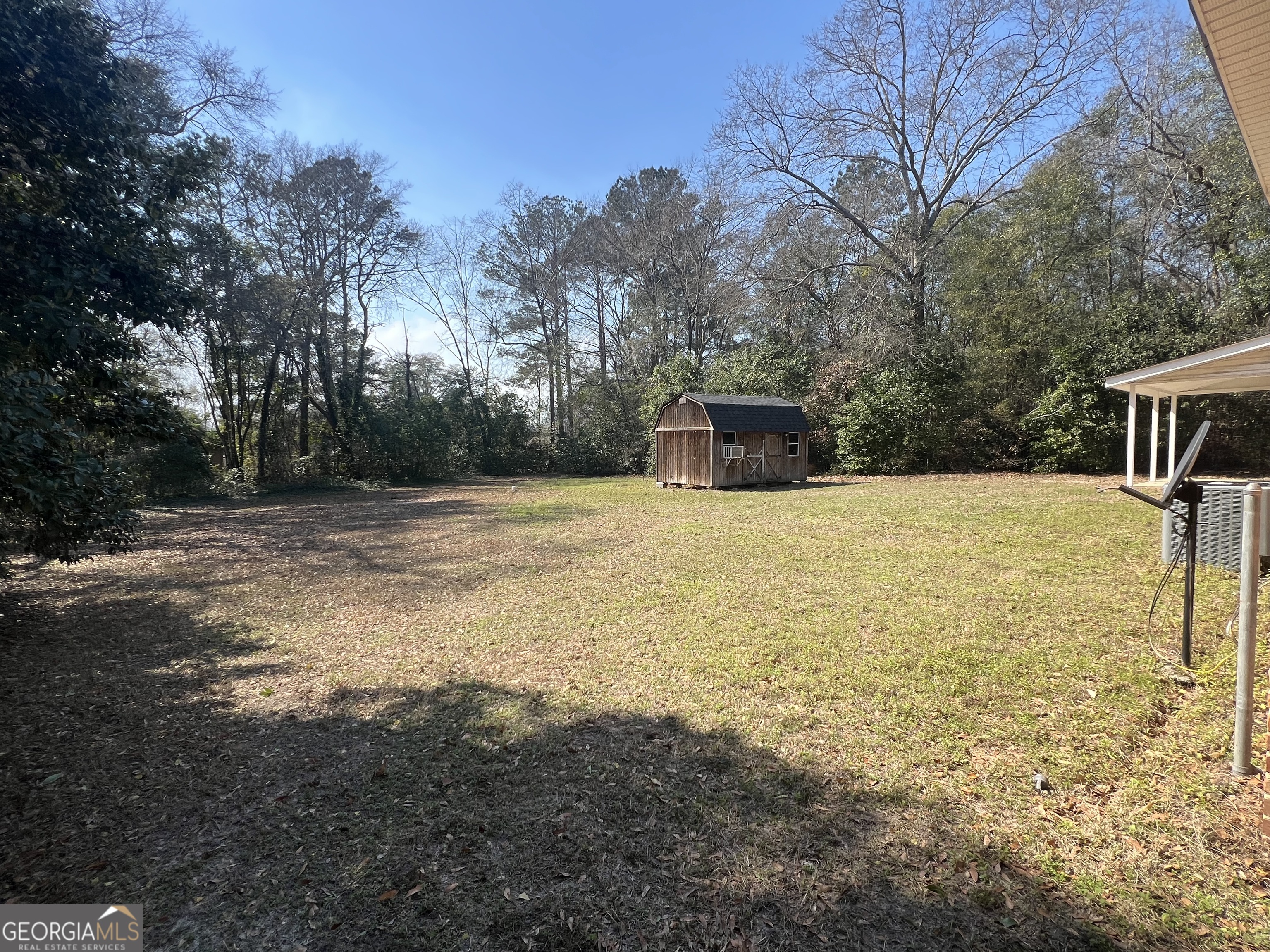1342 North Jefferson Street Dublin, GA 31021 - Photo 5 of 15 a view of pool with trees in the background