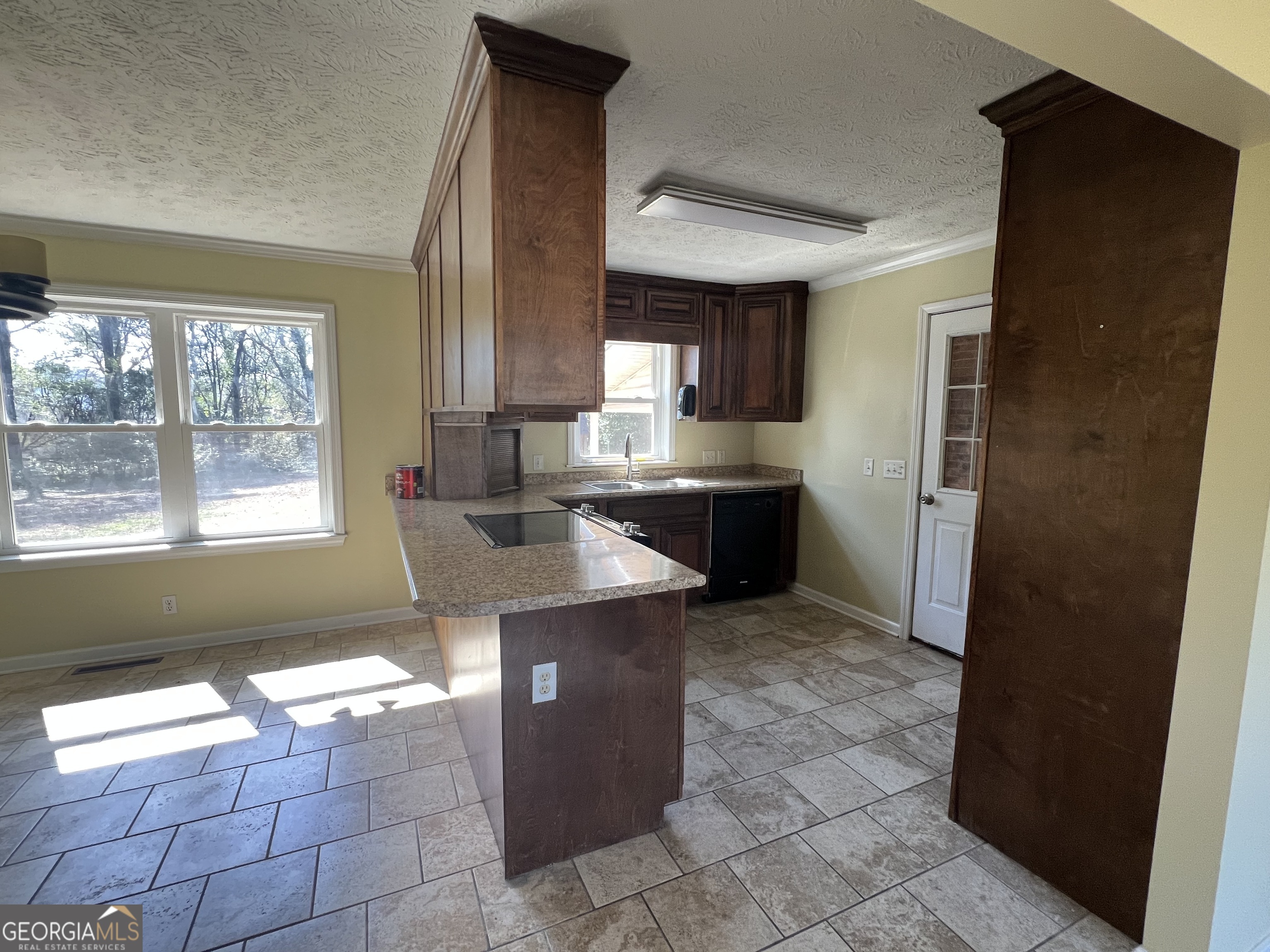 1342 North Jefferson Street Dublin, GA 31021 - Photo 6 of 15 a kitchen with a counter top space and appliances