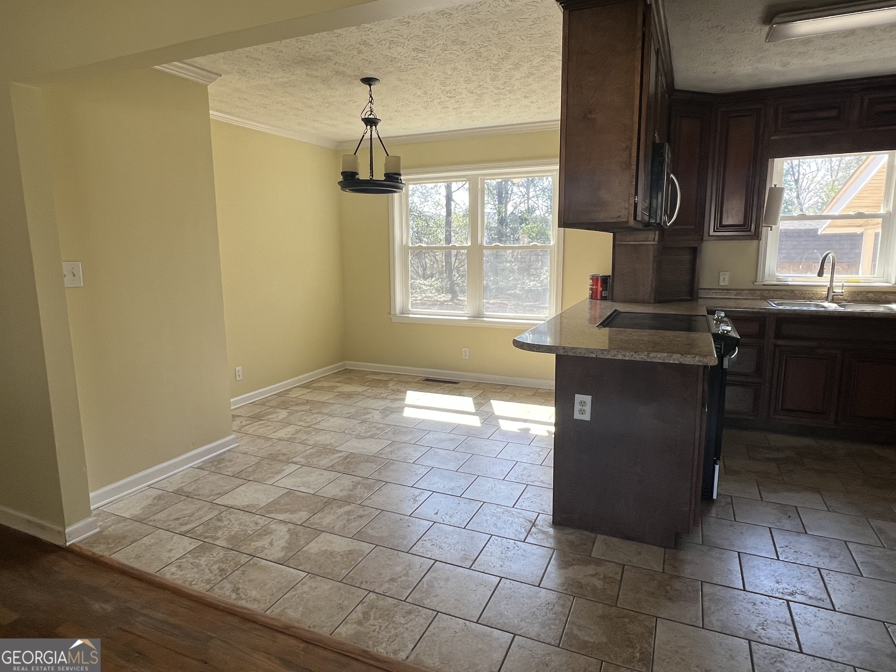 1342 North Jefferson Street Dublin, GA 31021 - Photo 7 of 15 a kitchen with a stove a sink and a cabinets