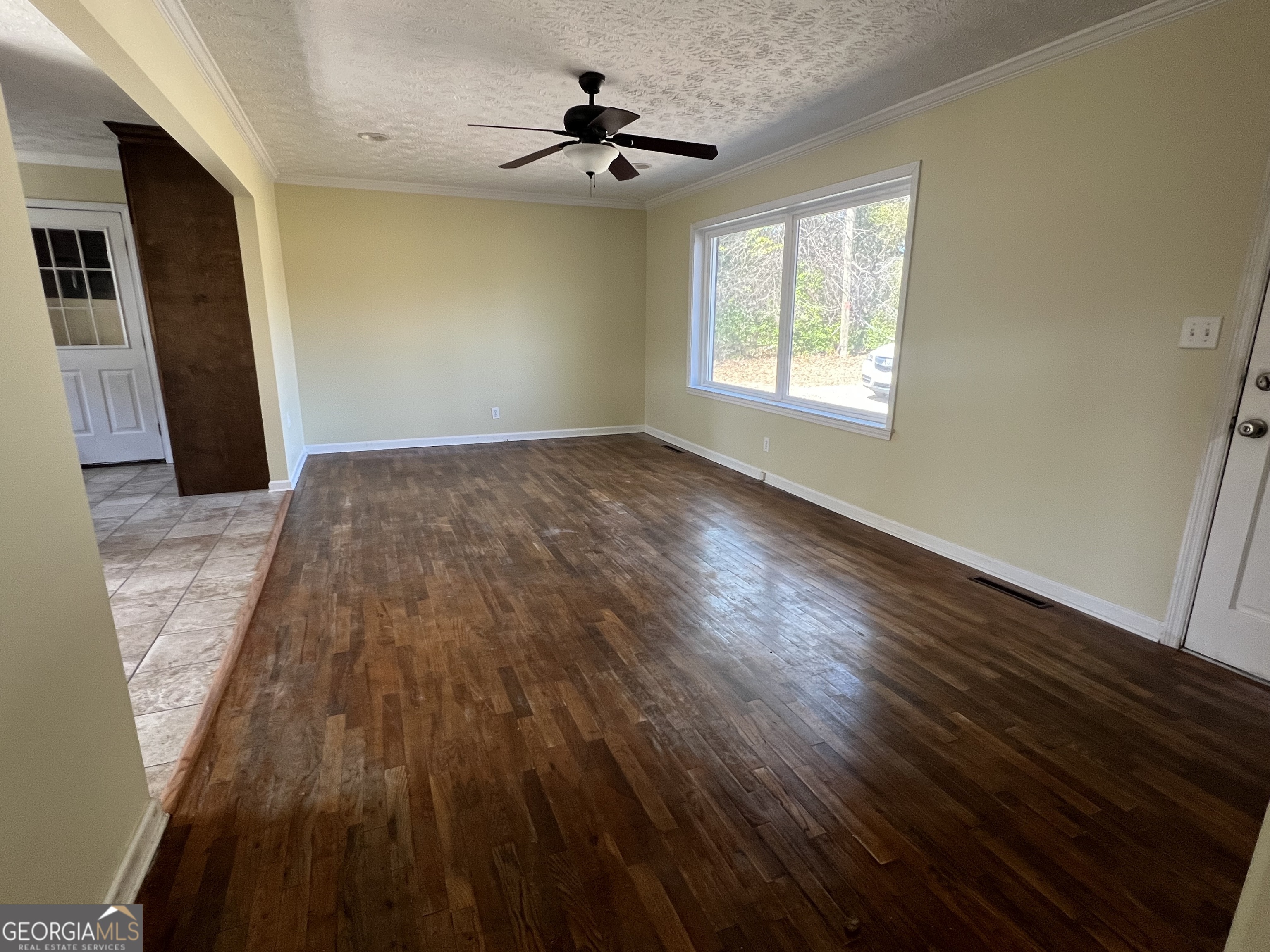 1342 North Jefferson Street Dublin, GA 31021 - Photo 9 of 15 a view of empty room with wooden floor and fan