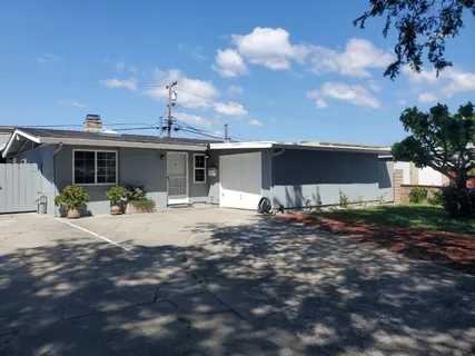 a front view of a house with yard and garage