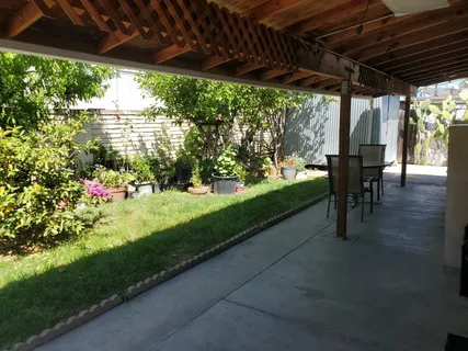 a view of a porch with furniture and yard