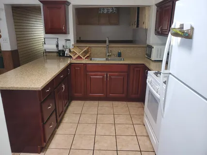 a kitchen with a sink a stove and a microwave