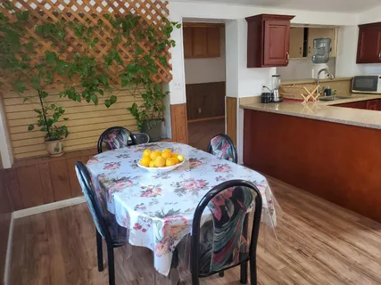a view of a dining room with furniture and a kitchen view