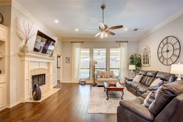a living room with furniture a fireplace and a flat screen tv