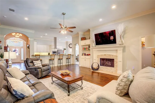 a living room with furniture a fireplace and a flat screen tv