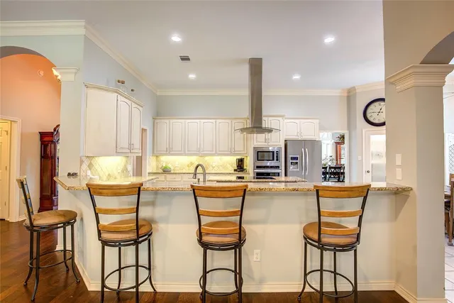 a view of a kitchen with dining table and chairs