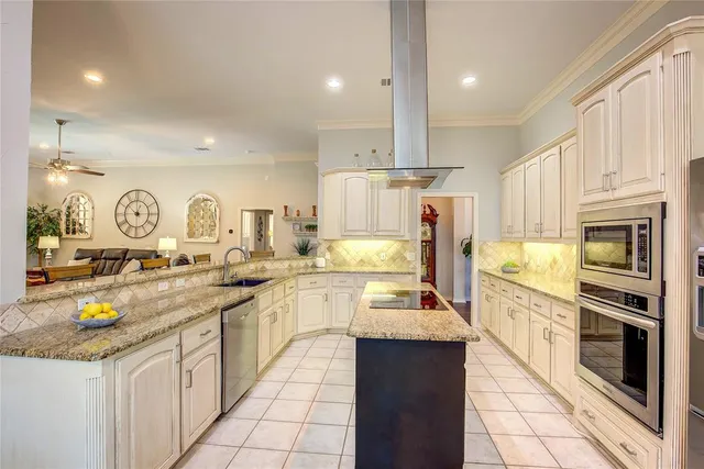 a kitchen with stainless steel appliances granite countertop a stove oven and a refrigerator