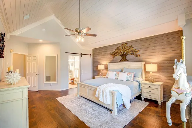 a bedroom with a large bed and a chandelier