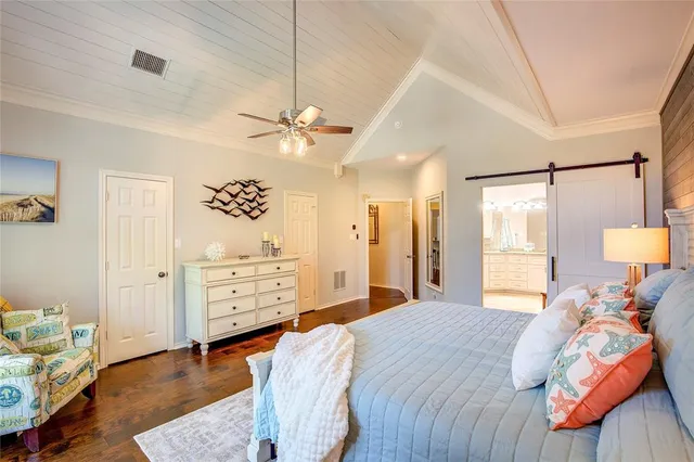 a bed room with a bed and a chandelier