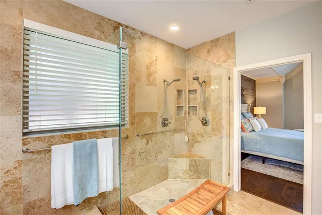 a large bathroom with a large mirror vanity and shower