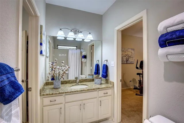 a bedroom with bed and a chandelier