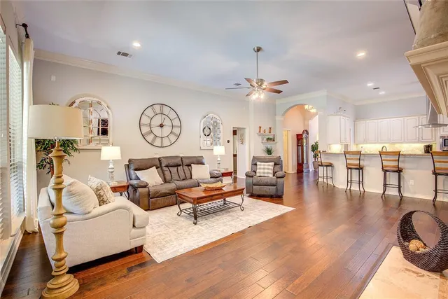 a living room with lots of furniture and view of kitchen