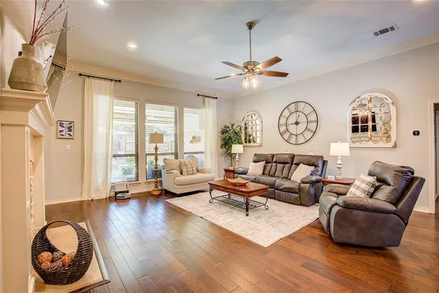 a living room with fireplace furniture and a large window