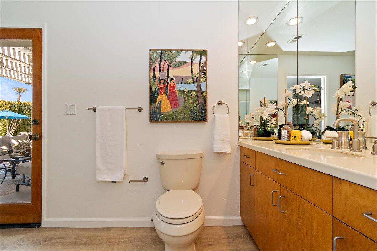 70140 Sun Valley Drive Rancho Mirage, CA 92270 - Photo 19 of 36 a bathroom with a toilet sink and mirror