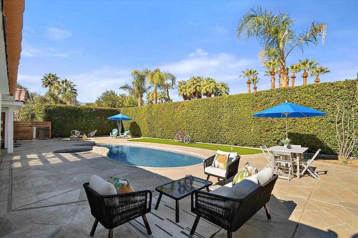 70140 Sun Valley Drive Rancho Mirage, CA 92270 - Photo 27 of 36 a view of a swimming pool with lounge chairs