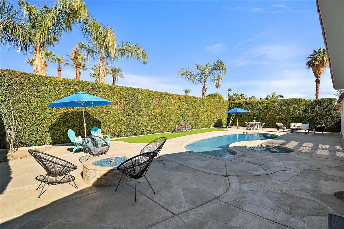 70140 Sun Valley Drive Rancho Mirage, CA 92270 - Photo 28 of 36 a view of a patio with a table and chairs under an umbrella