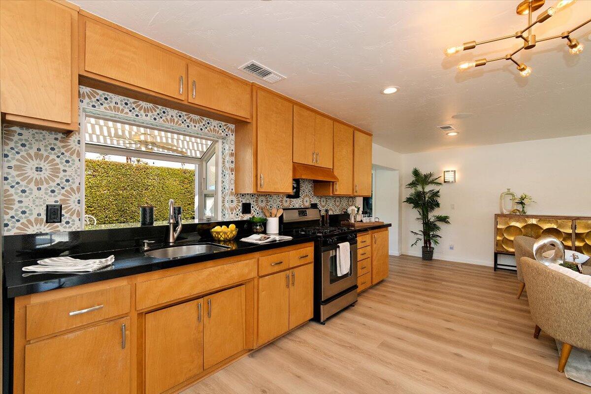 70140 Sun Valley Drive Rancho Mirage, CA 92270 - Photo 4 of 36 a large kitchen with stainless steel appliances a lot of counter space and a sink