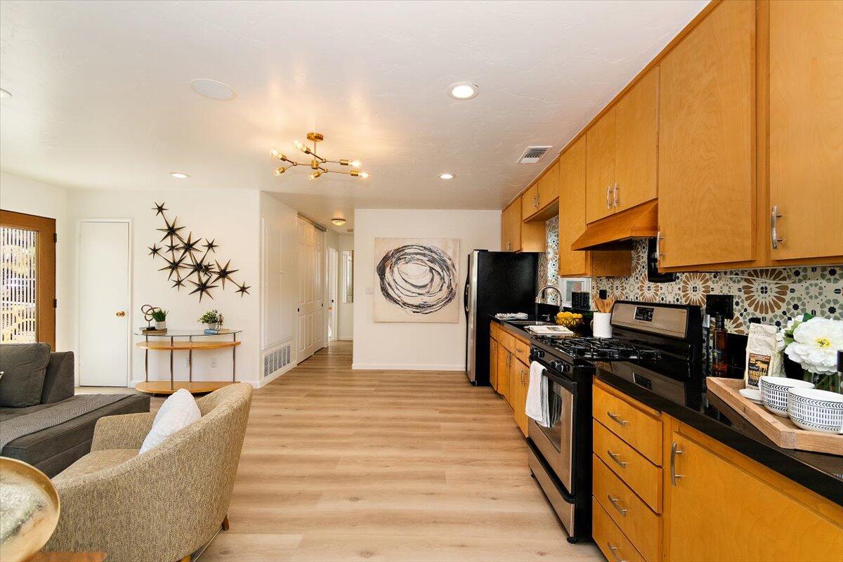 70140 Sun Valley Drive Rancho Mirage, CA 92270 - Photo 6 of 36 a kitchen with granite countertop a stove a sink and a refrigerator