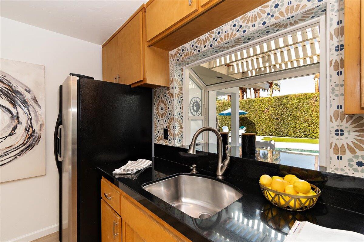 70140 Sun Valley Drive Rancho Mirage, CA 92270 - Photo 7 of 36 a kitchen with granite countertop a refrigerator and a sink