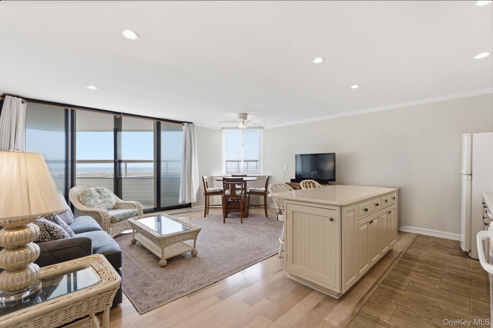 253 Dune Road, Unit 49 Westhampton Beach, NY 11978 - Photo 4 of 31 a living room with furniture and a large window