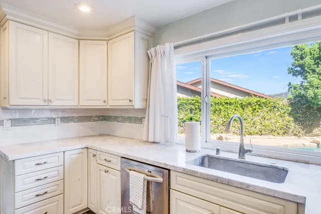 a kitchen with appliances cabinets and a large window