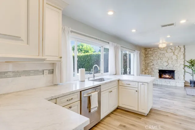 a kitchen with a sink cabinets and window