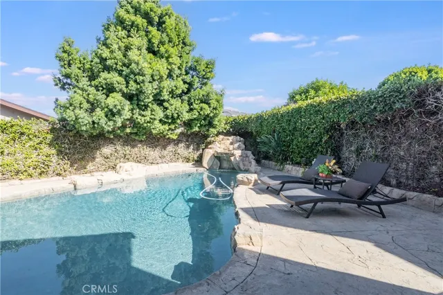 a view of a backyard with sitting area