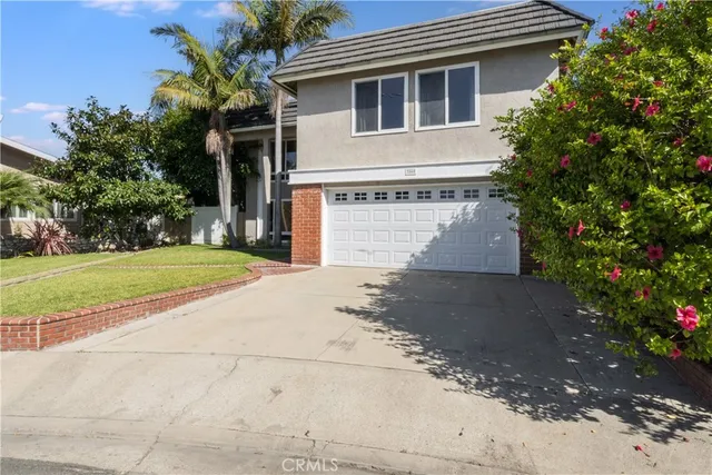 a front view of a house with a yard and a garage