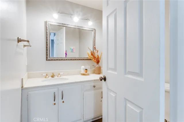 a bathroom with a sink vanity and mirror