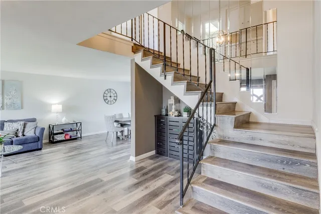 a view of entryway and hall with wooden floor