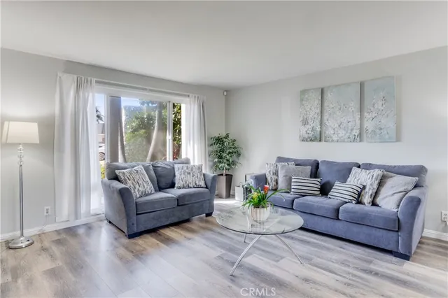 a living room with furniture and a potted plant