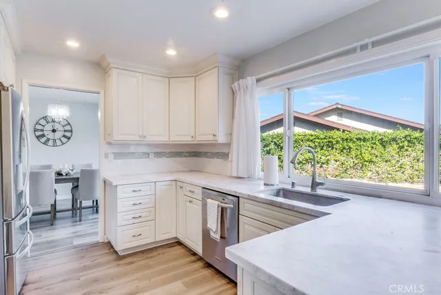 a kitchen that has a lot of cabinets and wooden floor
