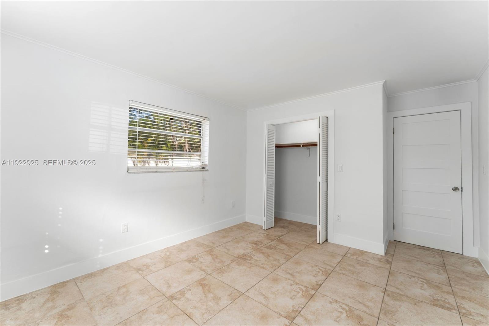 201 Galen Drive, Unit 104 Key Biscayne, FL 33149 - Photo 8 of 17 a view of an empty room with a window