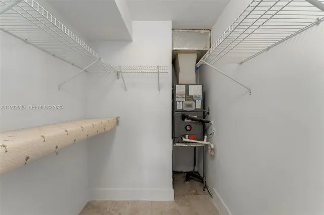a view of storage and utility room with closet