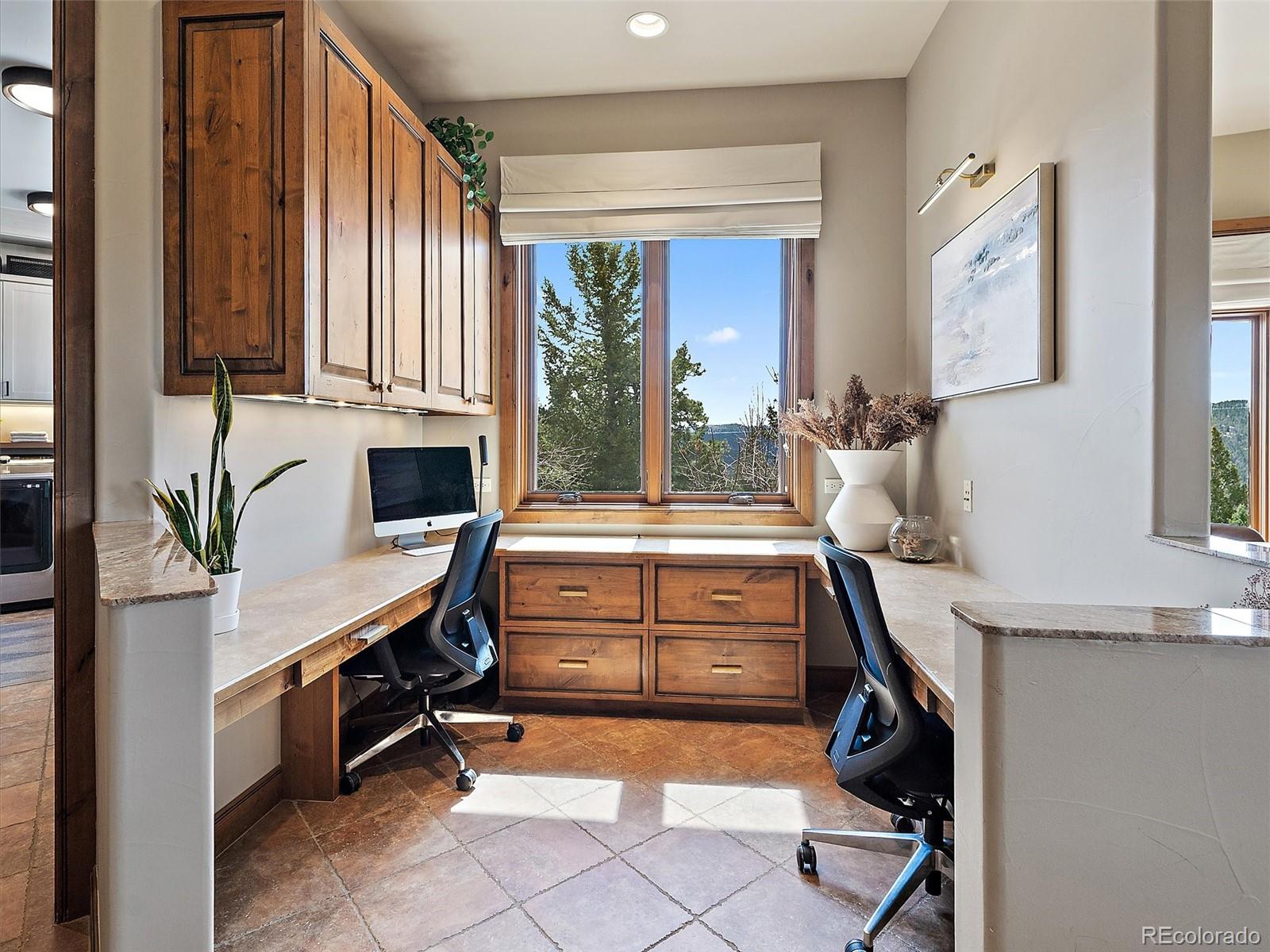 32024 Snowshoe Road Evergreen, CO 80439 - Photo 16 of 50 a room with lots of furniture and a window