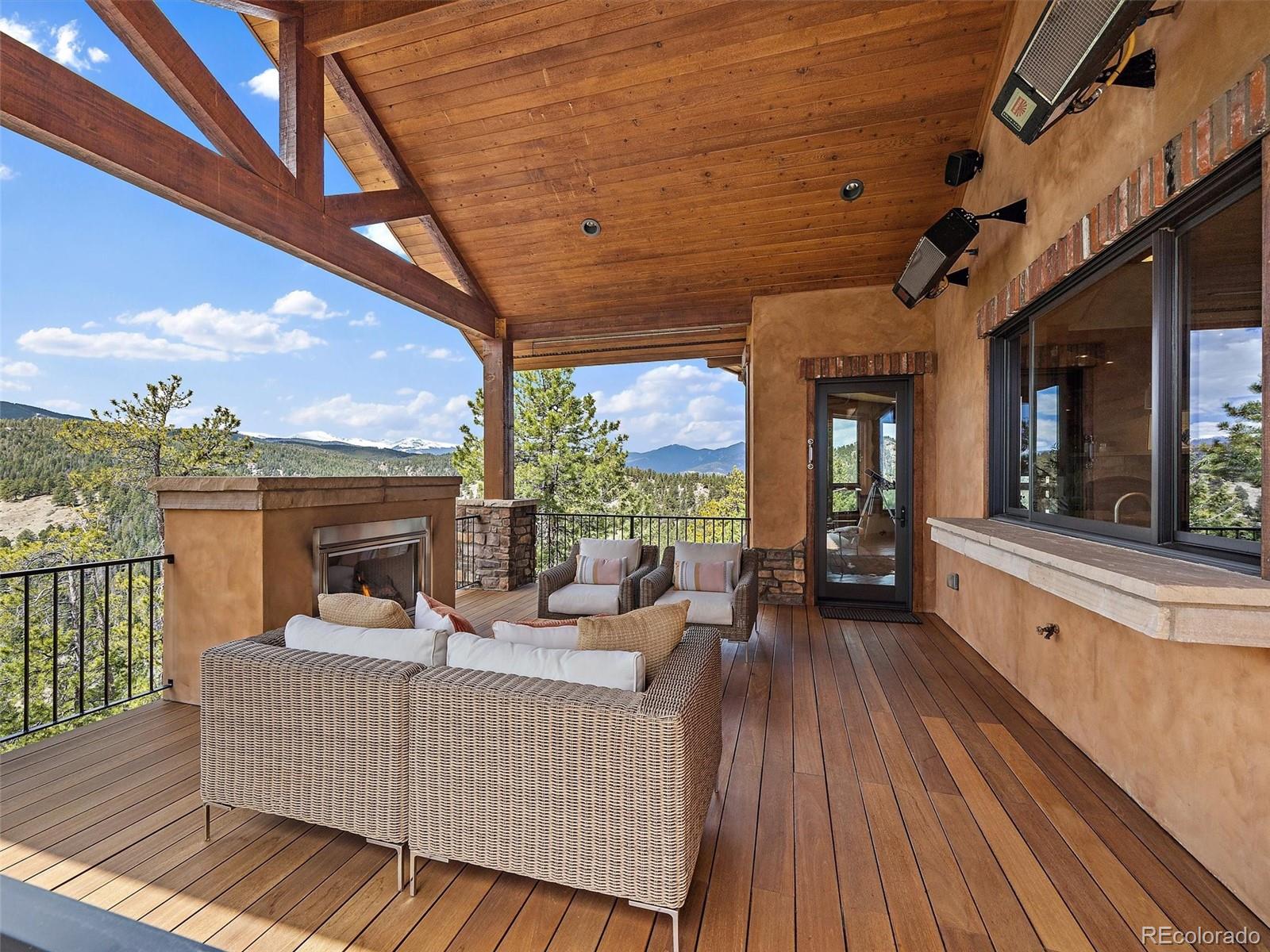 32024 Snowshoe Road Evergreen, CO 80439 - Photo 22 of 50 a view of a roof deck with couches
