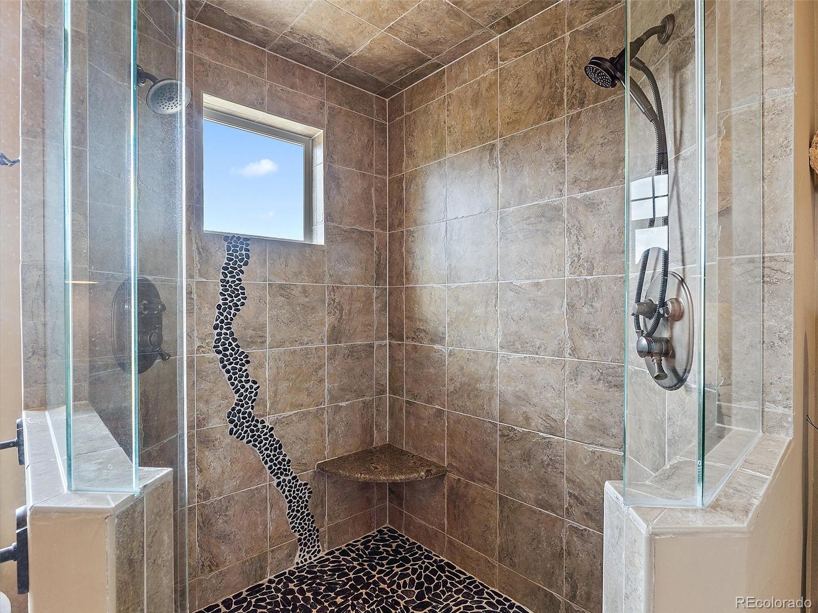32024 Snowshoe Road Evergreen, CO 80439 - Photo 29 of 50 a bathroom with a shower