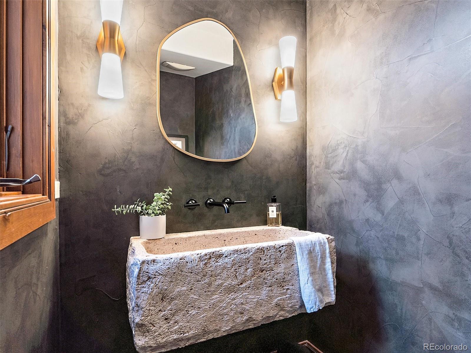 32024 Snowshoe Road Evergreen, CO 80439 - Photo 31 of 50 a bathroom with a sink and a mirror
