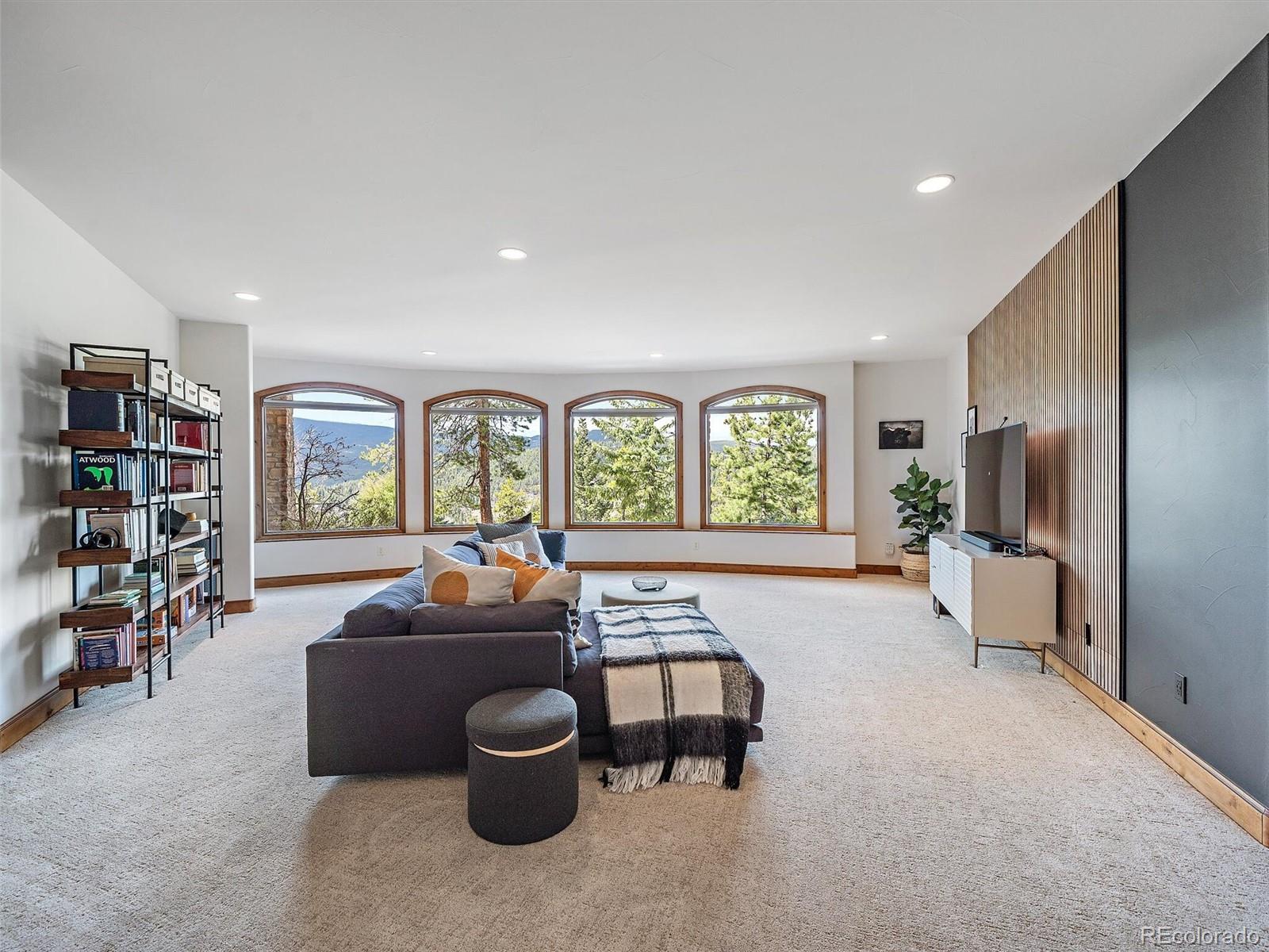 32024 Snowshoe Road Evergreen, CO 80439 - Photo 32 of 50 a living room with furniture and a large window