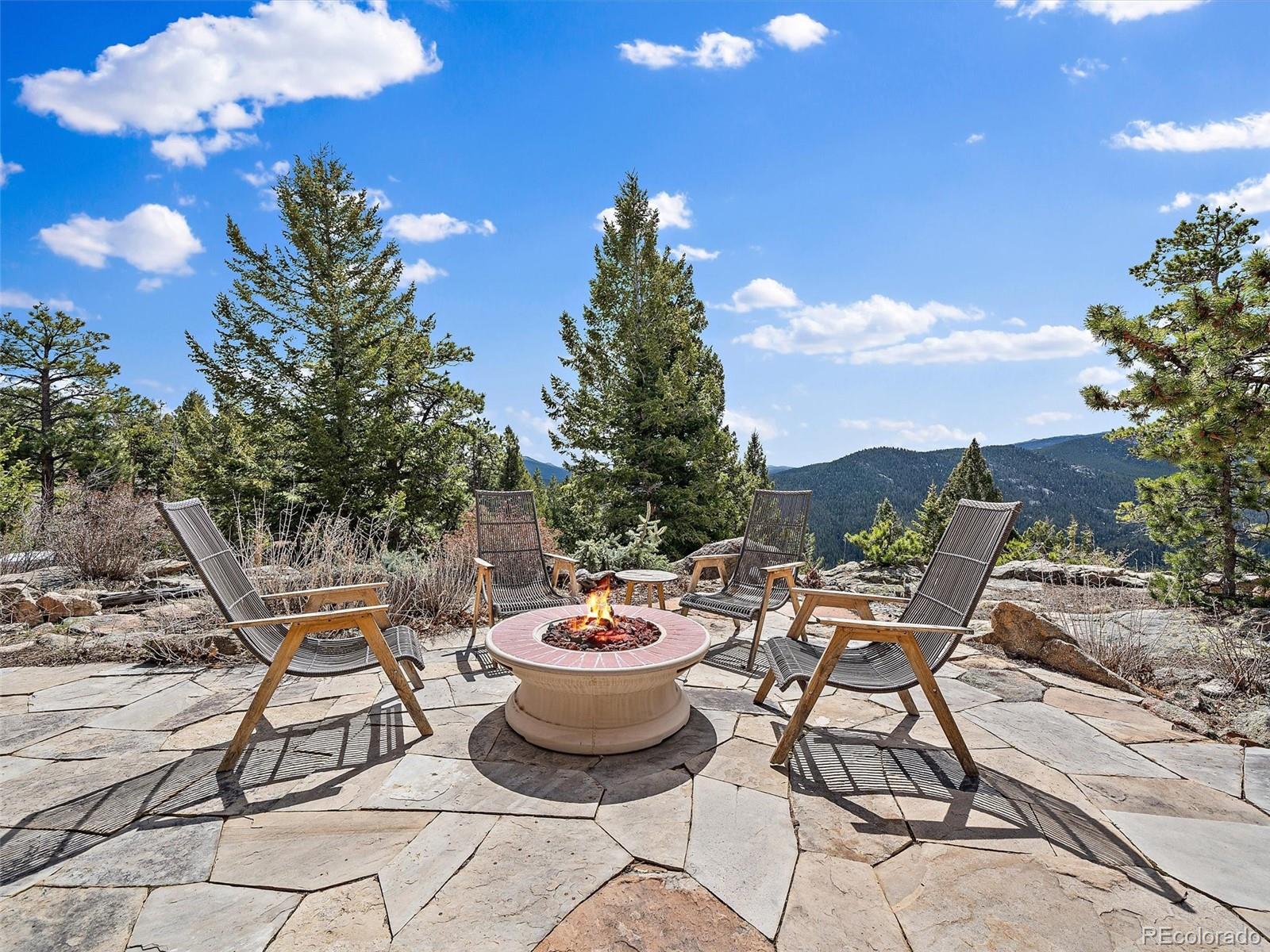 32024 Snowshoe Road Evergreen, CO 80439 - Photo 33 of 50 a outdoor space with a table and chairs