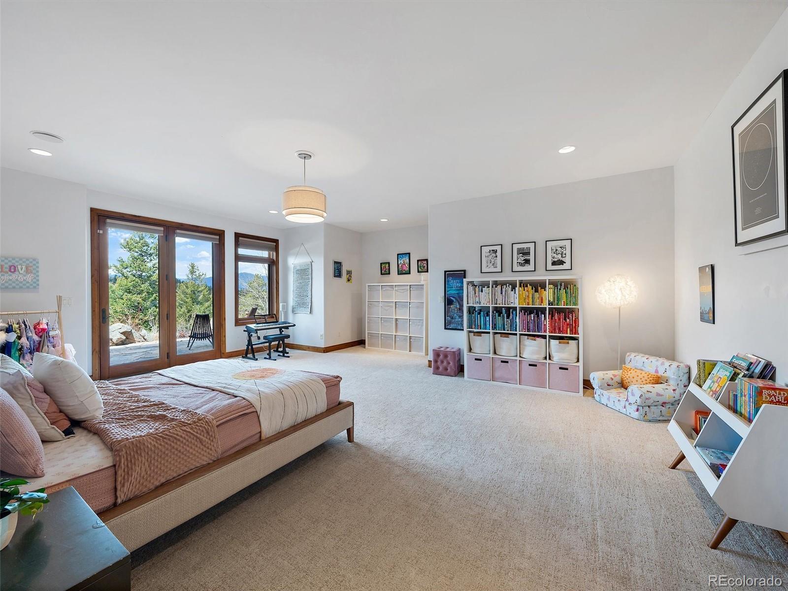 32024 Snowshoe Road Evergreen, CO 80439 - Photo 35 of 50 a bedroom with a bed furniture and a window
