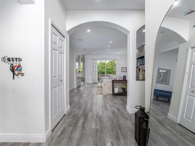 a living room with furniture and large windows