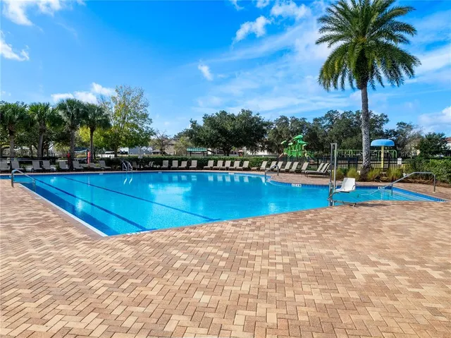a view of house with backyard and furniture