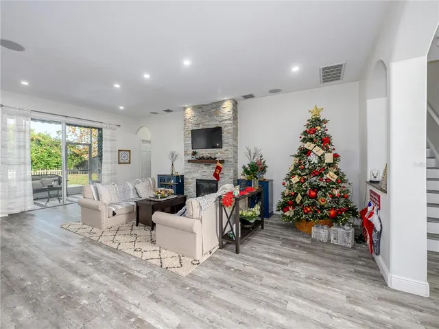 a living room with furniture a flat screen tv and a fireplace